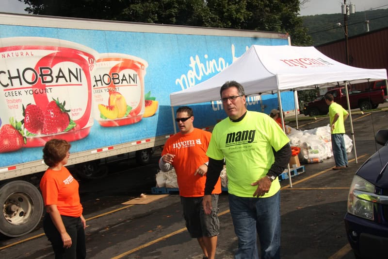 Employees walking in front of a Chobani truck