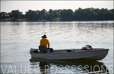 Man fishing on fishing boat in a lake